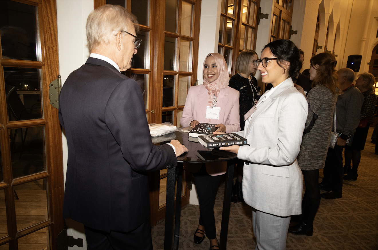 <em>Bulletin</em> board fellows Giovana Rodrigues Manfrin (right) and Reja Younis (center) speak to keynote speaker David Ignatius of <em>The Washington Post</em> at the 2024 annual event.